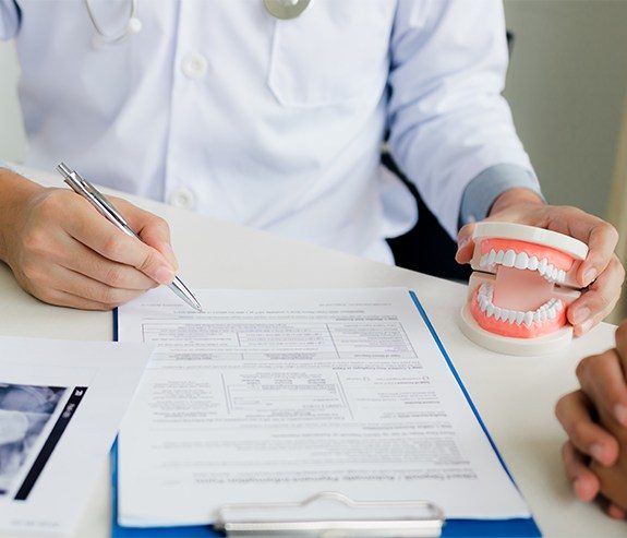Patient completing dental insurance forms