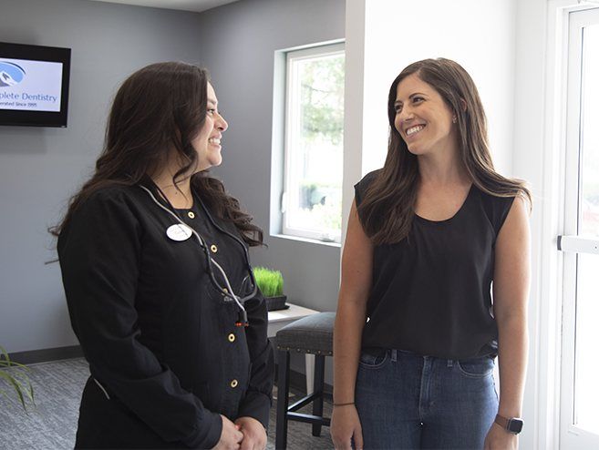 Dental team member smiling at patient during dental checkup visit