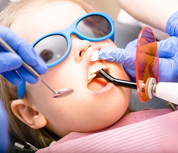 Child receiving dental treatment