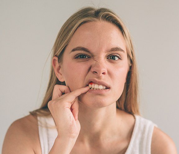 Woman pointing to a soft tissue injury