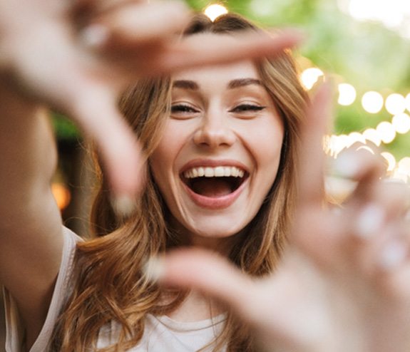 Woman framing her face with her fingers