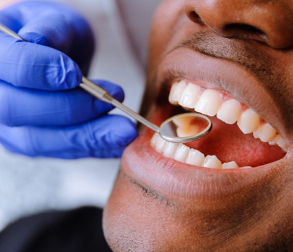 a dentist examining a patient’s teeth