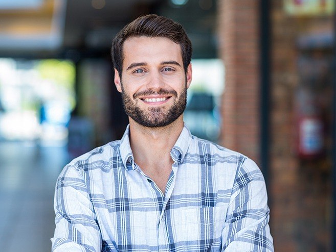 Man sharing healthy smile after dental crown restoration