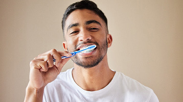 Man brushing teeth to prevent dental emergencies in Longmont