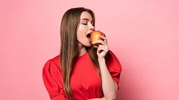 Woman taking a bite out of an apple