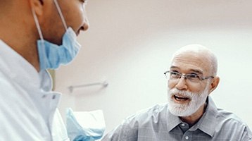 Older man discussing All-On-4 dentures