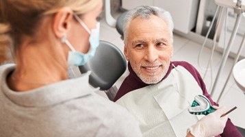 A dentist taking dental impressions for a patient’s future dentures 