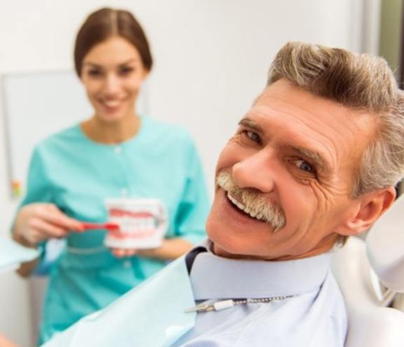 a patient visiting his dentist in Longmont to receive dentures