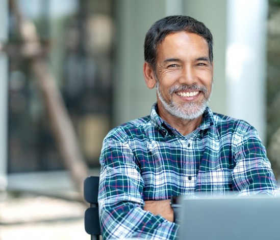 a man smiling about the benefits of dentures