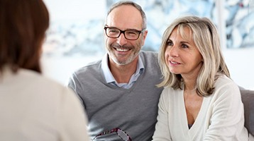 a man with dentures smiling and talking 