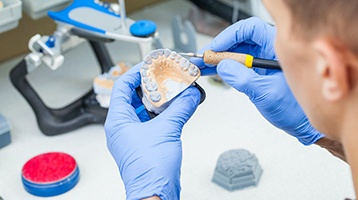 Lab technician carving dentures