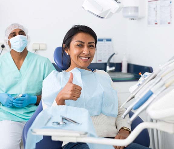 woman visiting Longmont emergency dentist giving thumbs up