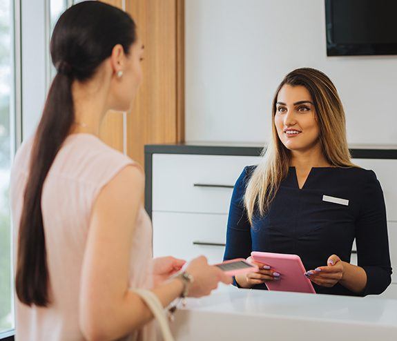 Dental team member and patient discussing financial options