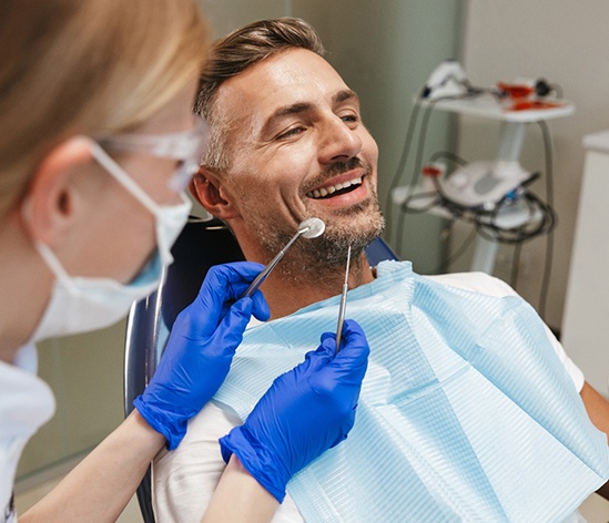 Man smiling about to have dental exam