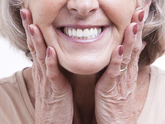 Closeup of woman with implant dentures in Longmont