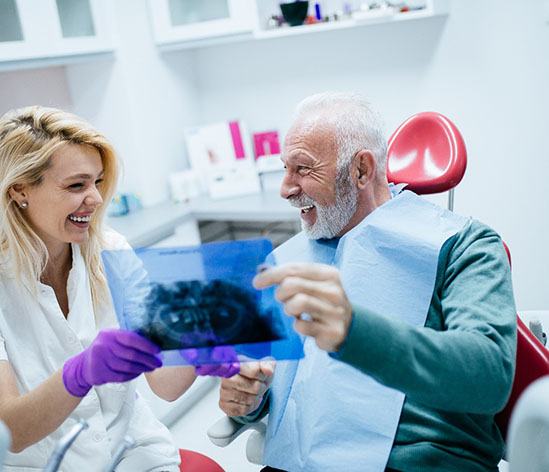 Man smiling at his new implant denture sin Longmont!