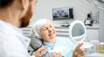 woman smiling after getting dental implants in Longmont