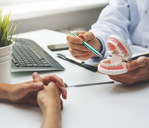 Dentist showing dental patient a smile model