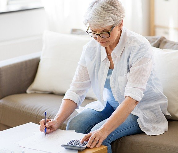 Woman calculating the cost of dental insurance