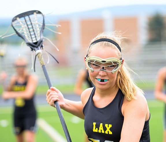 Teen girl with a blue mouthguard during athletic competition