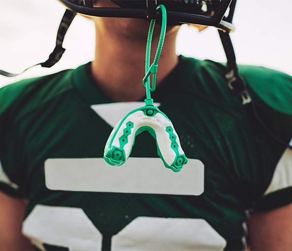 Mouthguard hanging from football helmet