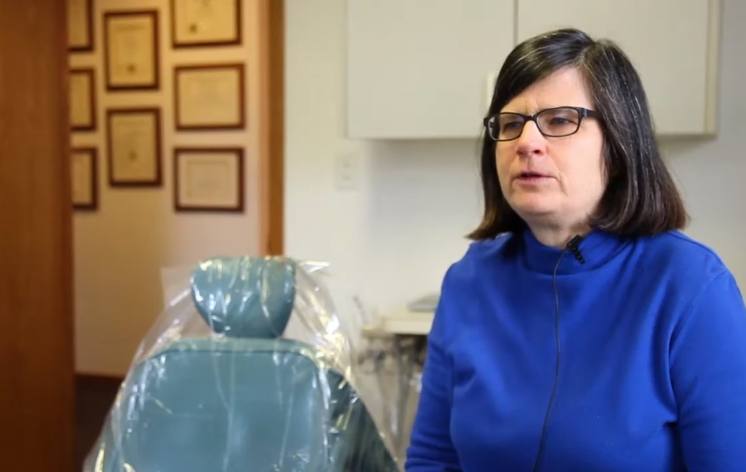 Longmont dental patient in blue jacket