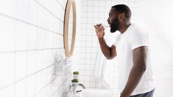 man rinsing his mouth after undergoing scaling and root planing