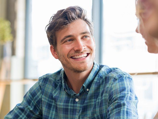 Man smiling after tooth colored filling restoration