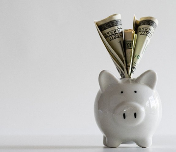 a piggy bank representing the cost of veneers in Longmont