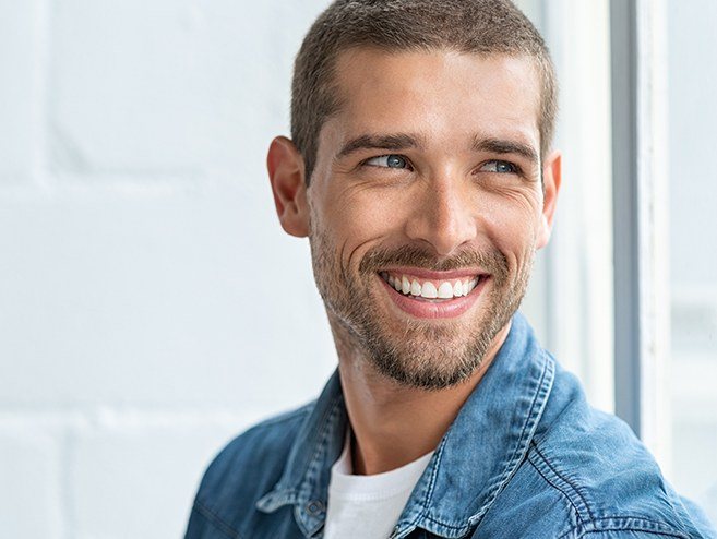 Man sharing bright smile after teeth whitening treatment