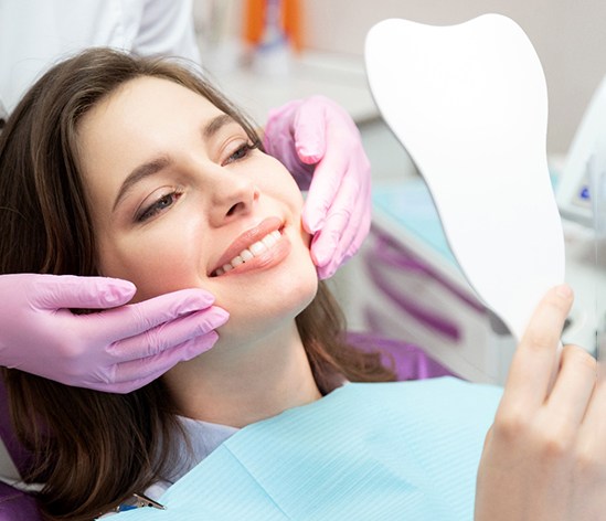 patient smiling while visiting cosmetic dentist