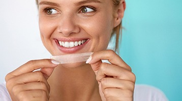 woman holding whitening strip