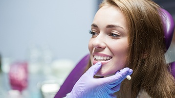 woman smiling while visiting dentist