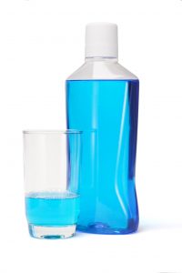 bottle of blue mouthwash white cap