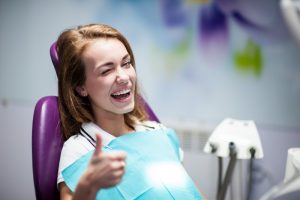 A woman smiling at her dental visit.