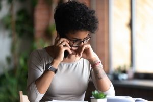 worried person speaking on their phone with an emergency dentist