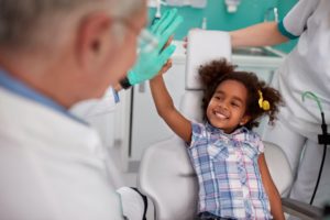 little girl high-fiving her dentist 