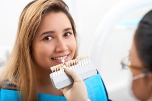 young woman trying on veneers for instant orthodontics 