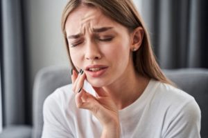 Woman suffering from a displaced tooth