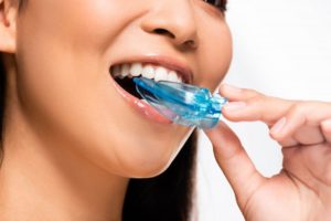 a woman placing her well-taken care of mouthguard