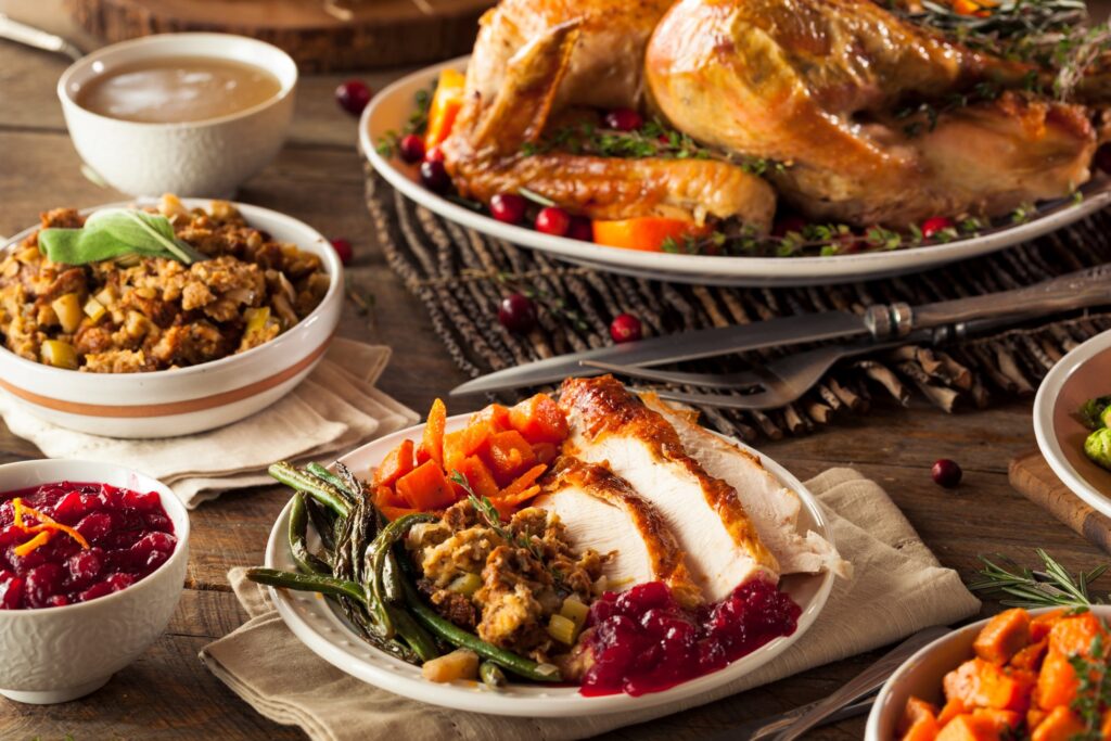 Thanksgiving dishes on table with plate filled with food