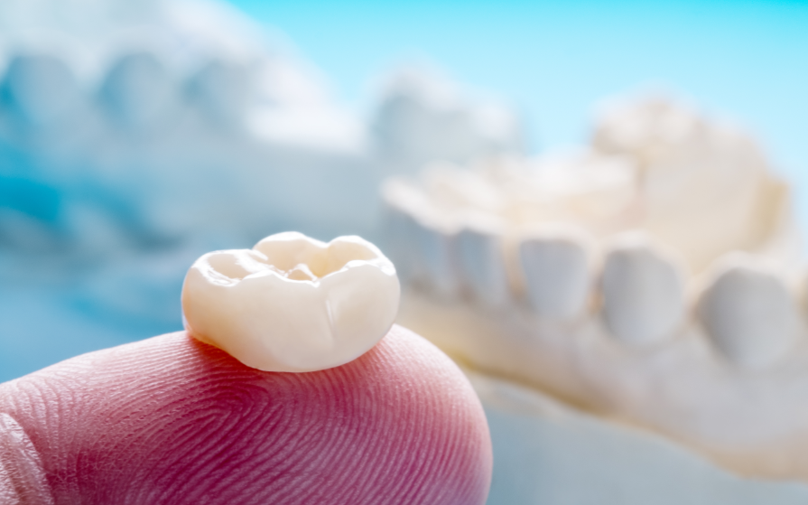 Dental crown on fingertip